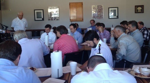 Dads praying together.