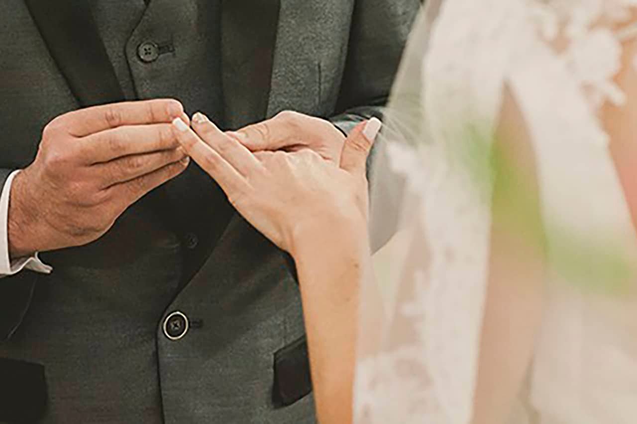Groom putting alliance during religious ceremony - wedding