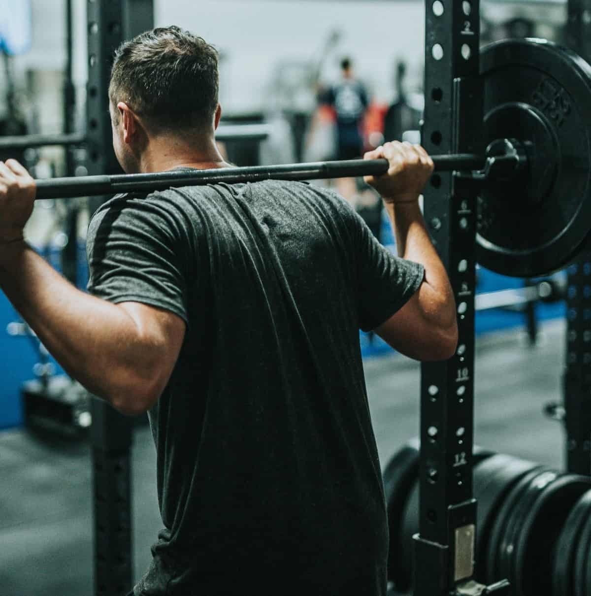A man lifting weights in a gym.