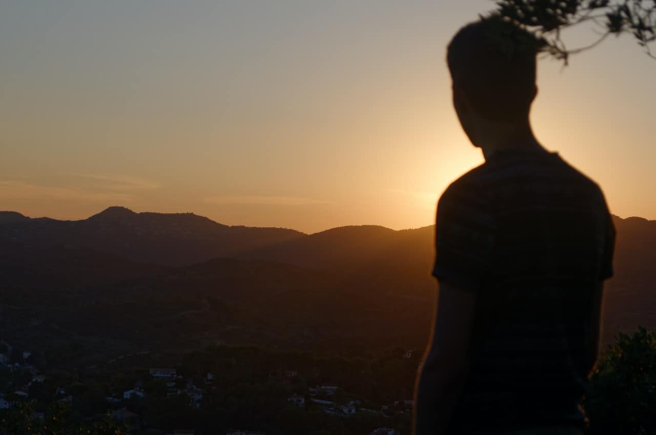 A man looking at the sunset.