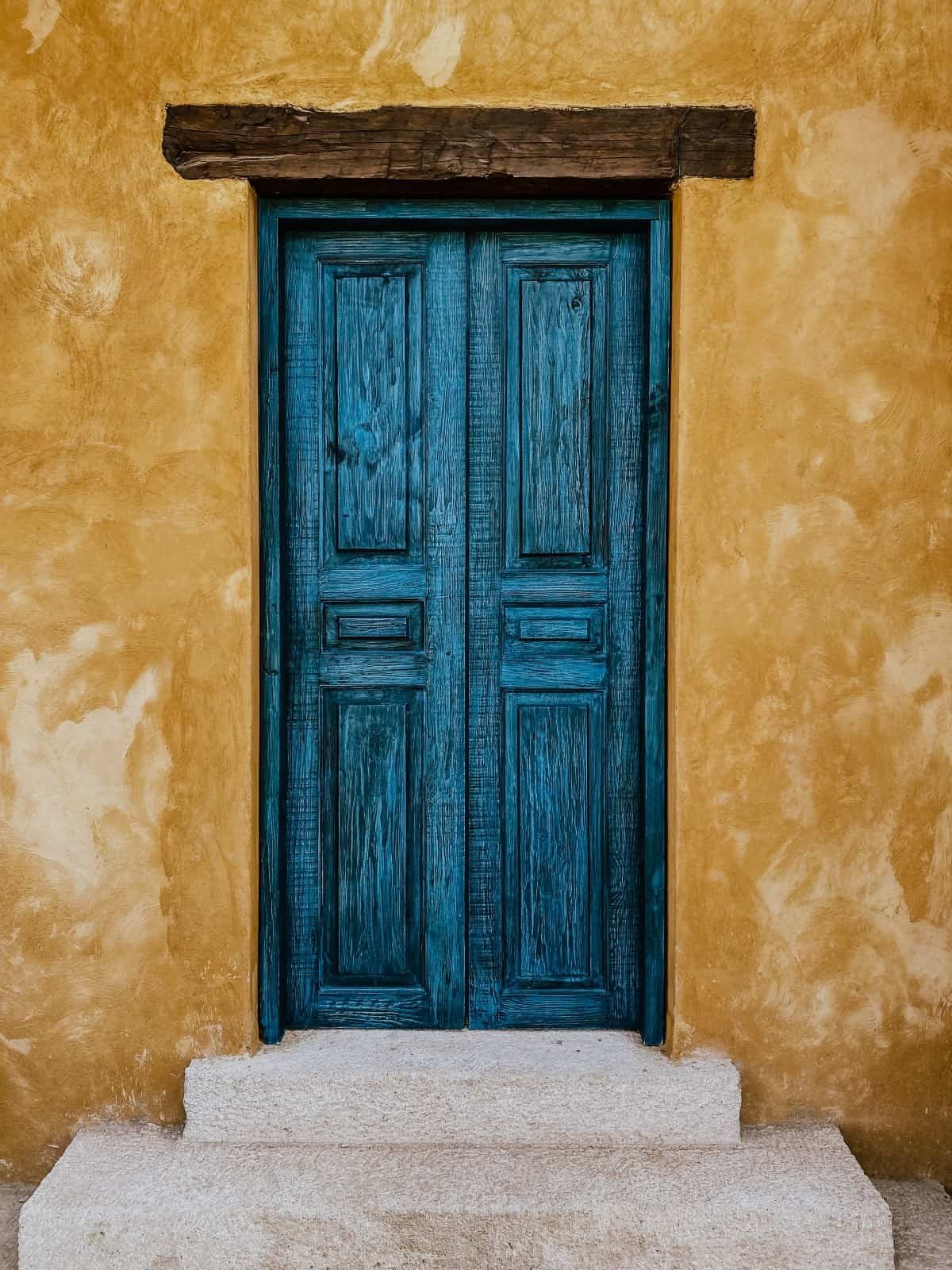 A wooden, turquoise door.