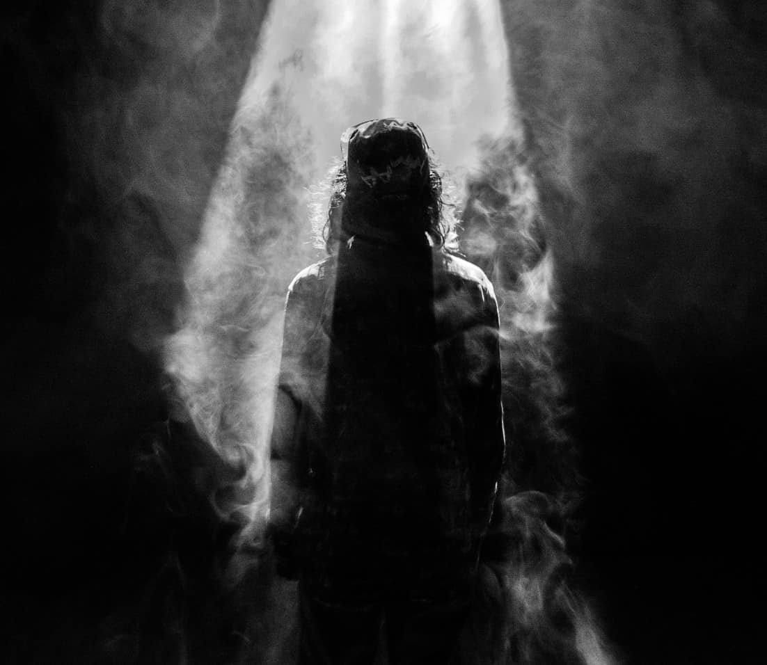 A silhouette of Jesus with a ray of light shining down.