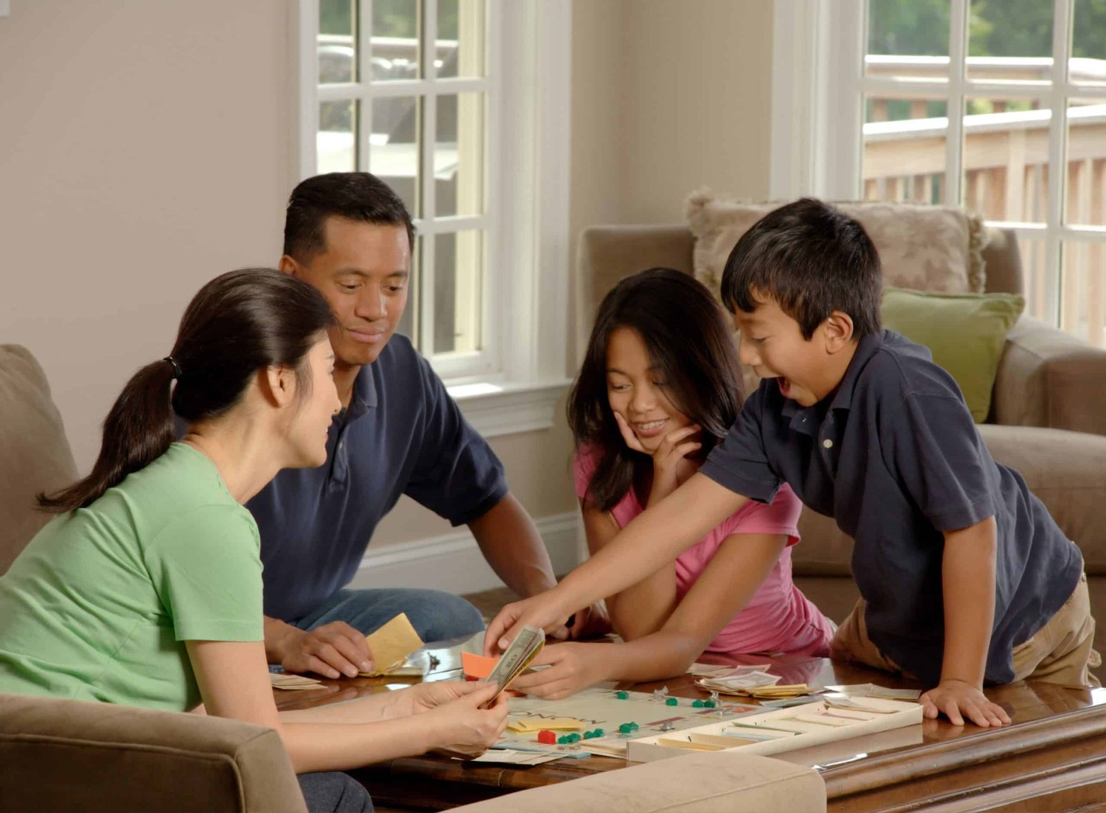 Family at table playing board game
