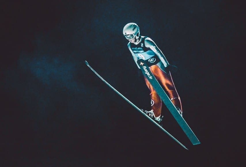 competitive snow skier in air