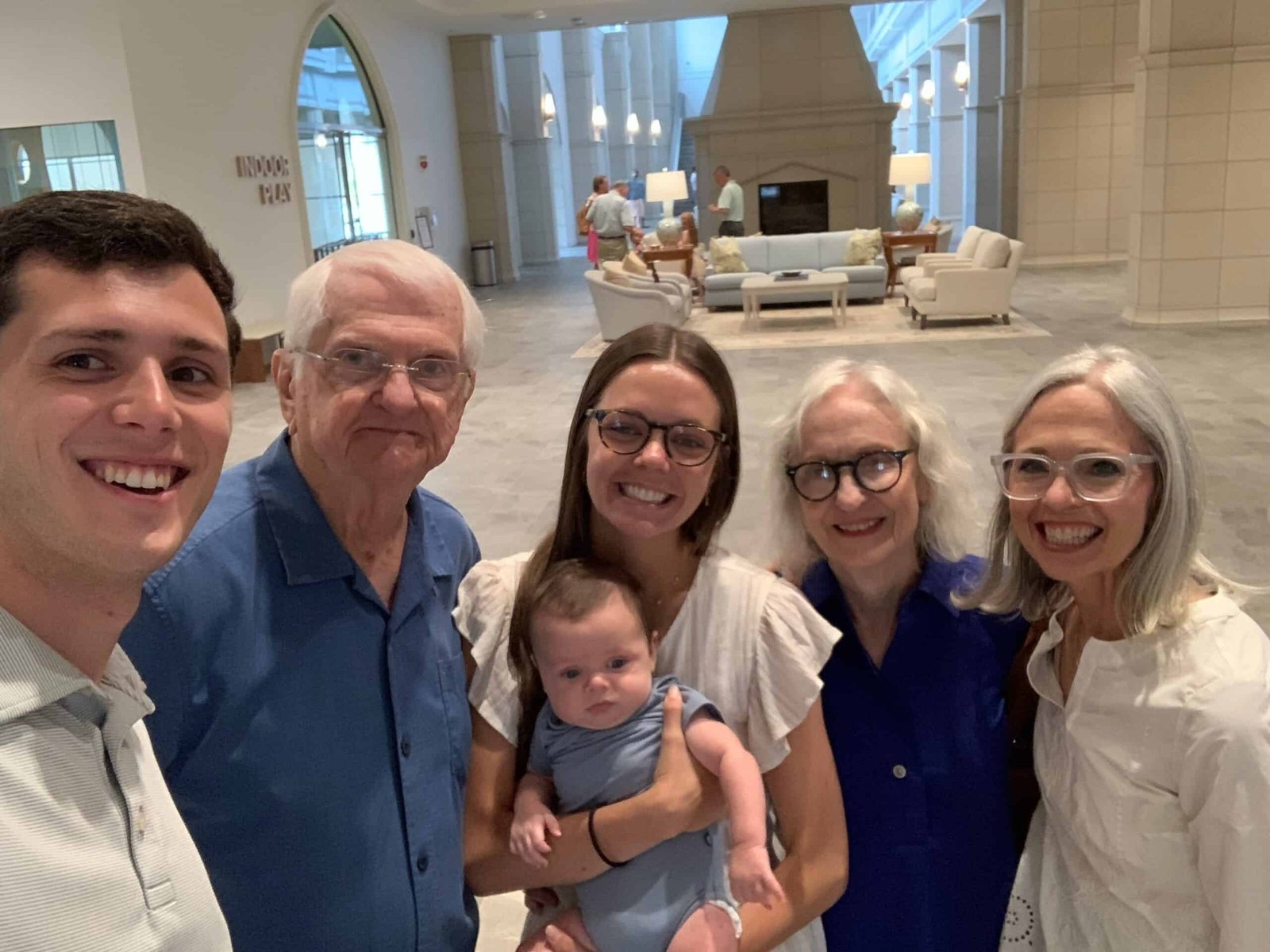 Group photo including 4 generations of a family.